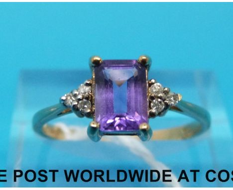 A 9ct gold ring set with an emerald cut amethyst and diamonds (size P) 