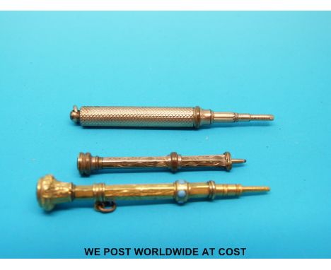 Three yellow metal miniature propelling pencils, one with intaglio finial, one hardstone with turquoise jewelling and an engi