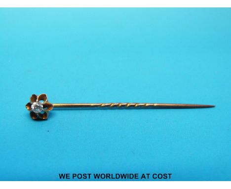 A yellow metal stick pin set with an old cut diamond 