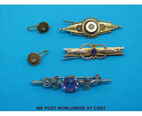 A hallmarked 15ct gold brooch set with a diamond, a 9ct gold brooch set with an amethyst and a pair of 15ct gold earrings set