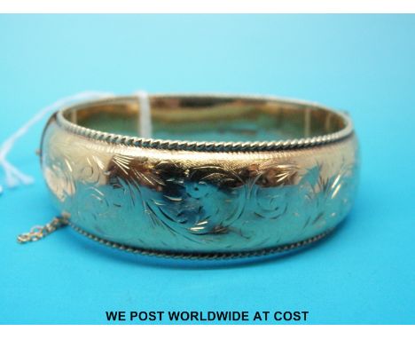 A hallmarked 9ct gold bangle with chased decoration, Chester 1960 (31.9g)
