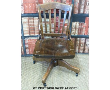 A vintage oak office swivel chair 