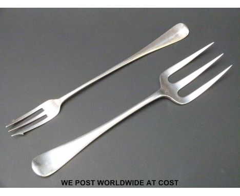 An early 20th century hallmarked silver serving fork, length 19cm (62g) together with a plated pickle fork 
