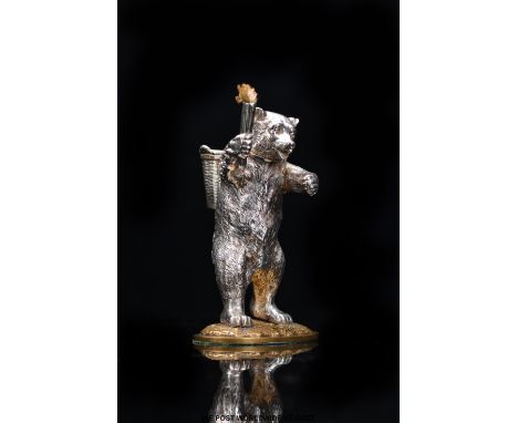 A Victorian novelty hallmarked silver table lighter formed as a bear with torch in one paw and basket to back, London 1876 ma