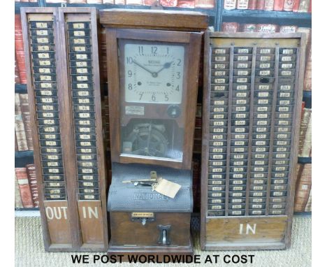 A National Time Recorder Co. Ltd., 'clocking in clock' St. Mary Cray, Kent, England, with two vintage clock card in/out stand