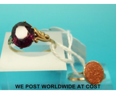 A yellow metal ring marked 9ct gold set with an amethyst and a yellow metal ring marked 9ct gold set with a sun stone