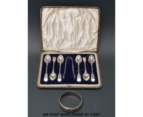 A cased set of hallmarked silver teaspoons and sugar tongs together with a hallmarked silver bangle (120g)