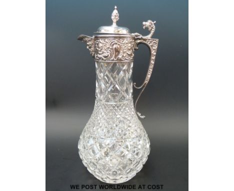 A hallmarked silver mounted glass claret jug with mask spout dragon thumb piece and pineapple finial, London 1973, maker Nat 