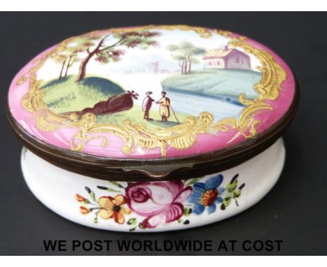 An 18thC enamel pill or patch box decorated with figures, river and house, 2.6cm tall and 6cm long