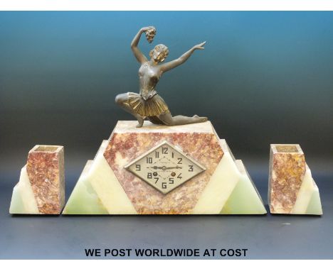 A tri-coloured marble Art Deco clock garniture with dancing lady to top, marked to dial F. Galveyrag