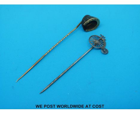 A yellow metal horse's hoof stick pin and a bicycle stick pin