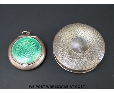 A hallmarked silver compact decorated with green guilloche enamel (diameter 4cm) and another hallmarked silver compact with e