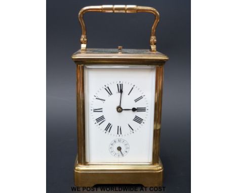 A French Gilt-brass Grande Sonnerie carriage clock with alarm, gorge case with oval top glass, white enamel dial with blue st