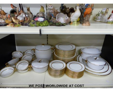 A Royal Doulton and Royal Worcester predominately twelve place setting dinner service including tureens, meat plates and bisc