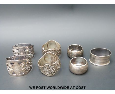 Three pairs of hallmarked silver napkin rings to include Walker & Hall and Iona Celtic design, together with a further silver