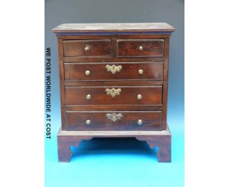 A 19thC mahogany apprentice chest of two over three graduated drawers, raised on bracket feet (37cm tall, 32cm wide, 20cm dee