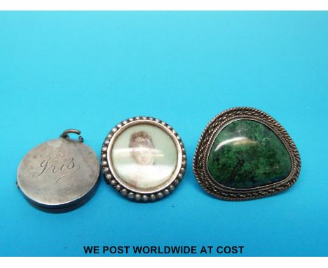 A hallmarked silver locket, hallmarked silver brooch set with malachite and a silver brooch set with a portrait miniature    