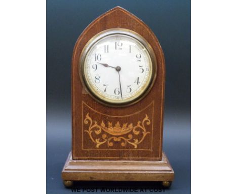 An inlaid Gothic style mantel clock in Mitre shaped case raised on brass ball feet 