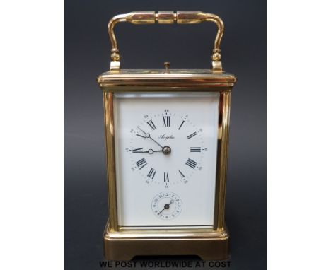 A brass repeater carriage clock striking on a gong. Angelus to white enamelled dial, Breguet style hands and secondary alarm 