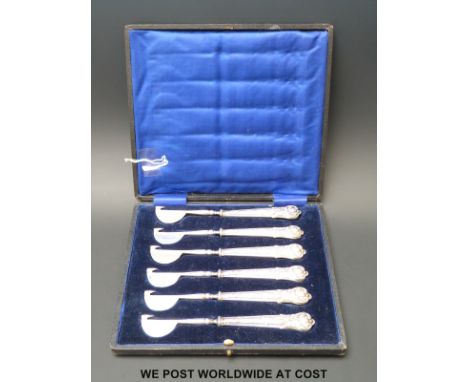 An unusual cased set of six hallmarked silver handled eating cutlery with half moon and point tools to end