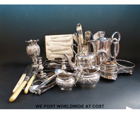 A collection of silver plate including a tankard, a boxed grape and nut cracker set, several vases, tea and coffee pot and cu