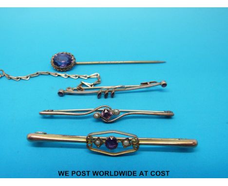 Three yellow metal bar brooches marked 9ct set with amethysts and seed pearls and a stick pin set with an amethyst