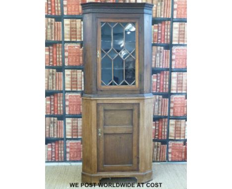 A 19thC oak astragal glazed corner cupboard with dentil moulded cornice, sphaped interior shelves and panelled cupboard raise