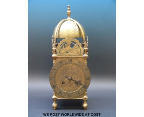 A large brass Lantern clock with two train movement and a single hand striking on a bell, decorated with a sailing ship 