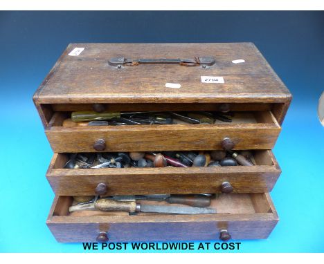 A toolmaker's chest containing jeweller's tools including dapping block, pliers etc