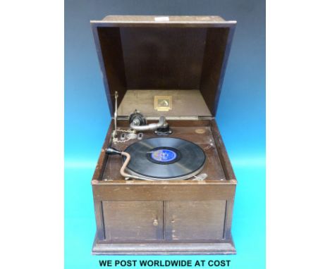 A c1930 HMV model 103 wind up gramophone in oak case with louvre type speaker outlet and door to control volume 
