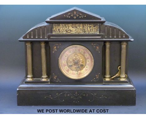 A two train slate mantel clock in classical style with pierced dial decoration, spade hands, brass pillars and Roman scene ab