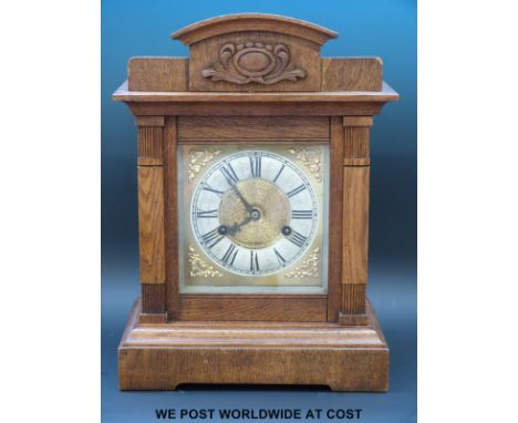 An oak cased mantel clock with two train Wurttemberg movement striking on the quarter with 'ting tang' gongs, the silvered ch