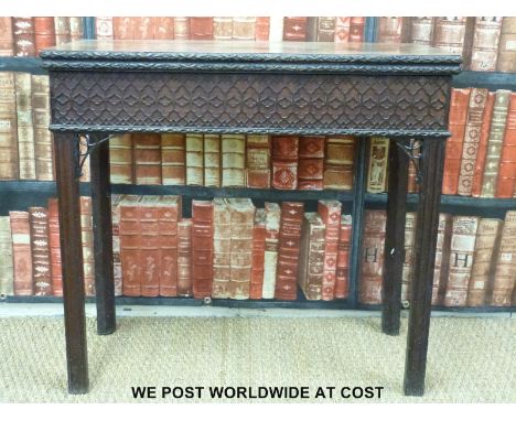 An unusual Georgian mahogany fold over card table with carved floral surround, moulded geometric frieze, single hidden drawer