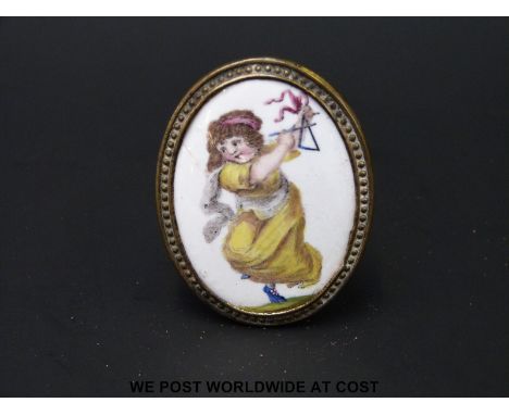 An 18thC English Bilston enamel oval cloak pin or chimney piece knob, polychrome decorated with a dancing child playing the t