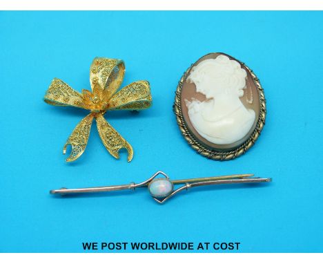 A yellow metal brooch marked 9ct gold set with an opal a silver gilt filigree brooch and a cameo brooch 