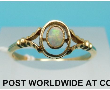 A yellow metal ring set with an oval opal cabochon, (size O)