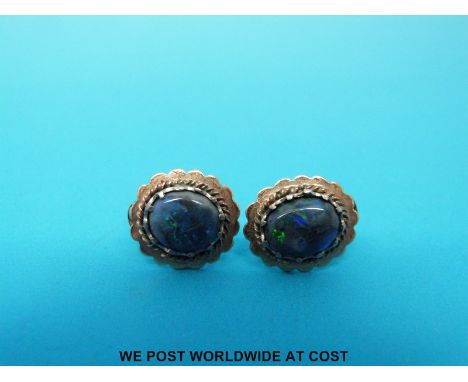 A pair of yellow metal earrings set with opal doublets 