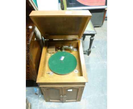 An internal horn gramophone with handle and vintage needle tins in light oak cabinet with USA Exhibitions Junior pick up 