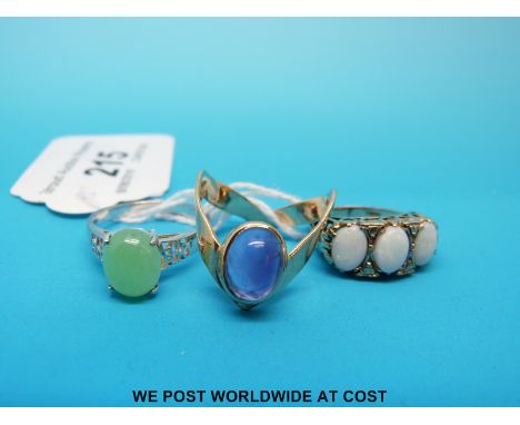 A 9ct gold ring set with three opals, a 9ct gold ring set with an amethyst and a silver ring