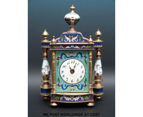 A French enamelled timepiece with pillared and finial decoration, Arabic numerals on white dial, raised on brass feet