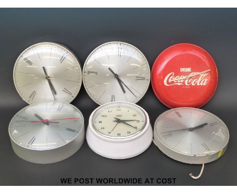 Four 'slave' dial clocks, together with an Astral electric clock and a Coca Cola advertising clock