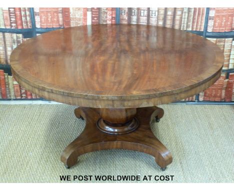 A 19thC circular mahogany breakfast table with crossbanded rosewood surround, supported on a bulbous tapering octagonal suppo