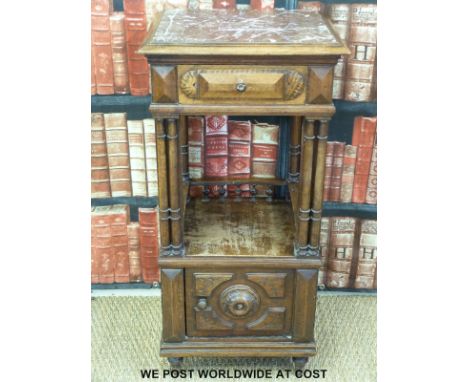 A late 19thC carved mahogany marble topped pot cupboard with single drawer above cubby hole with bobbin turned gallery over a