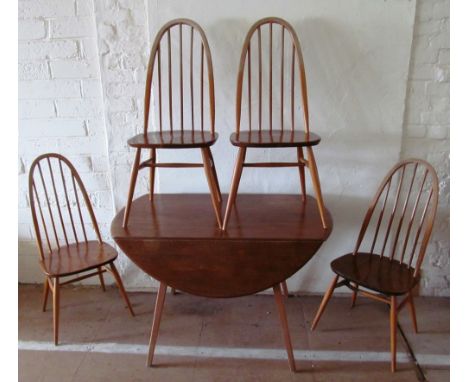 A light wood Ercol table and four chairs (one a/f faded top rails and slightly loose on back)