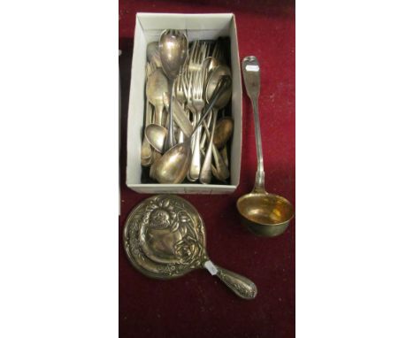 A plated ladle, some cutlery and a silver backed mirror embossed rose design