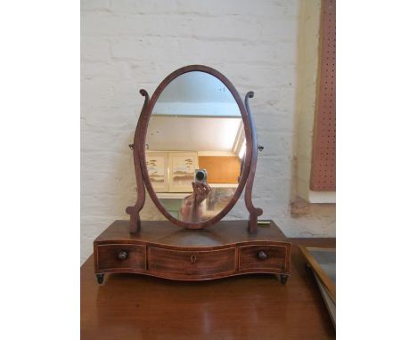 A Georgian mahogany serpentine toilet mirror