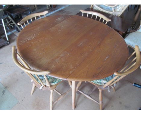 An Ercol dropleaf dining table on tapered supports