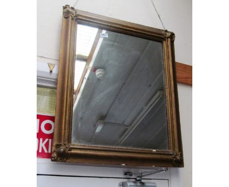 A gilt framed mirror