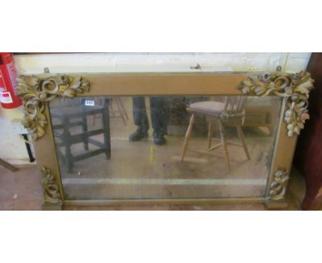A gilt overmantel mirror with leaf corners