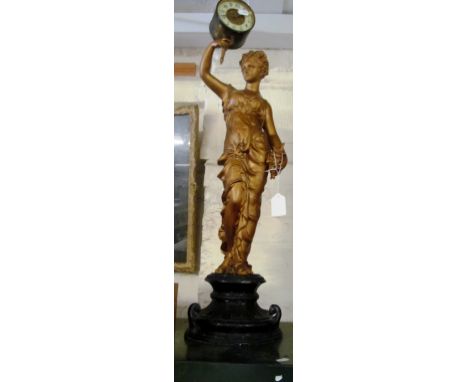 A gilt spelter clock of lady holding clock face